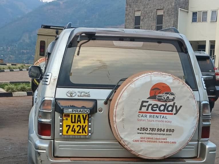 Rear view of a Toyota Land Cruiser Prado with hills behind